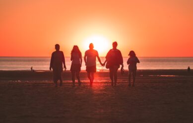 Family watching sunset in Gulf Breeze, FL